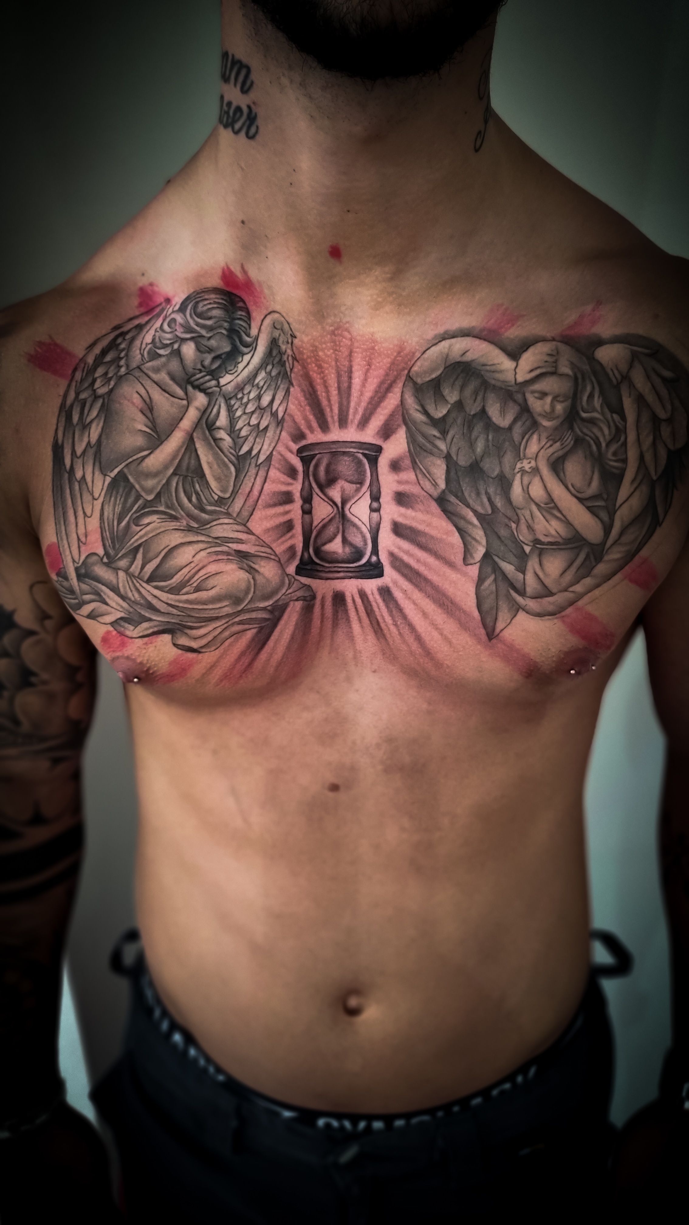 Oberkörper mit detaillierten Engels- und Stundenglas-Tattoos, expressionistisch und kontrastreich.